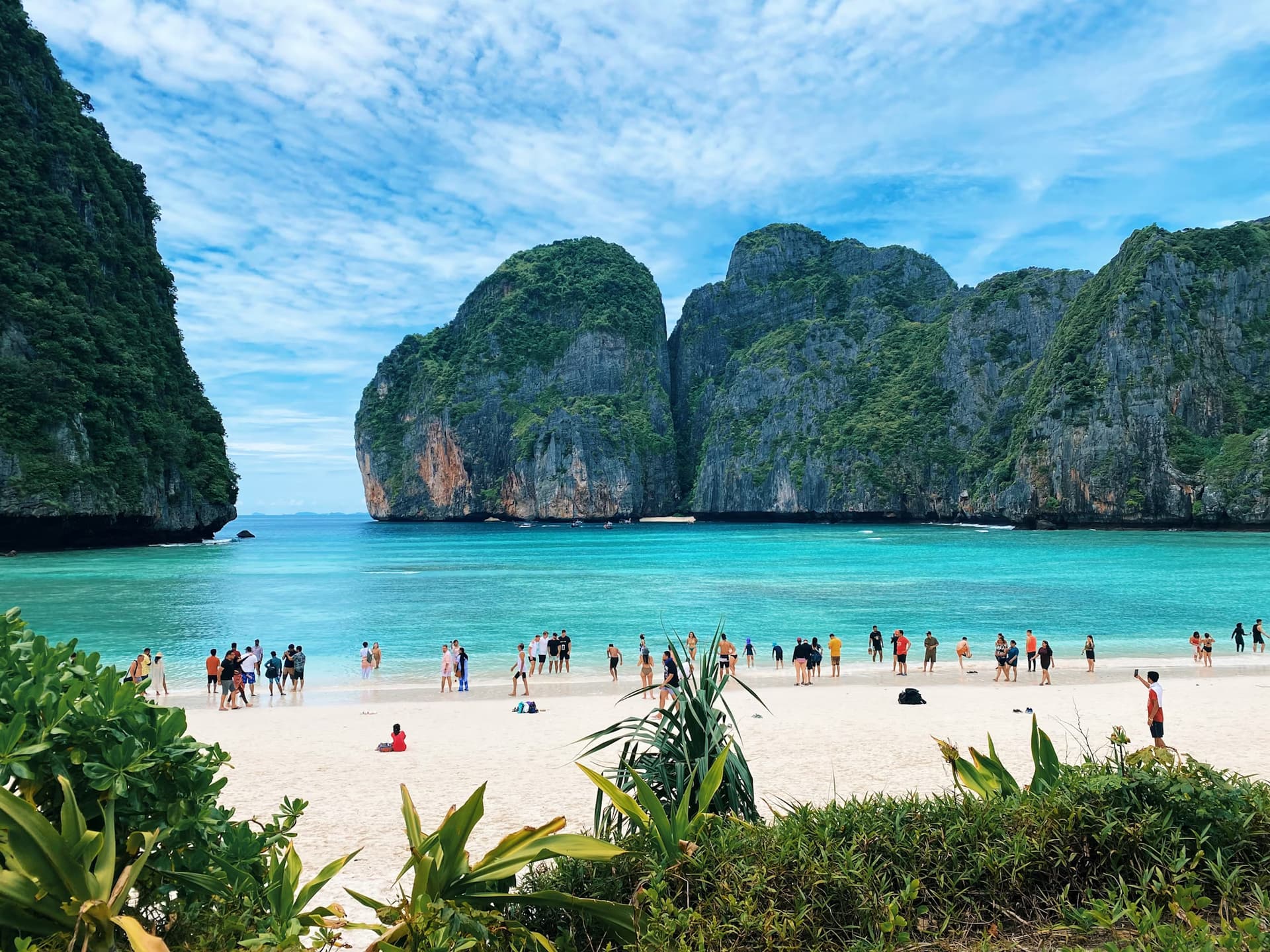 Long-tail boat cruising through Thai islands